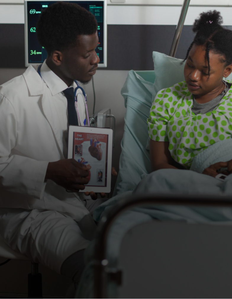 A doctor going through a chart at the bedside with a patient